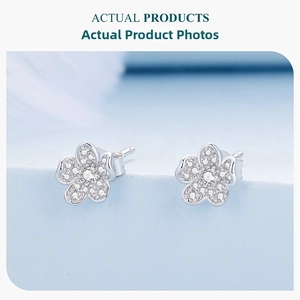 Macro shot of S925 sterling silver flower earrings with pavé white cubic zirconia