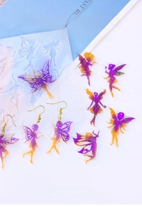 Macro view of DIY silicone earring molds with fairy wing resin pendants and glitter