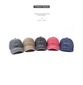 Group display of washed cotton baseball caps with freedom embroidery in five retro colors
