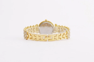 Detail view of the gold quartz watch back case and rhinestone-inlaid link strap