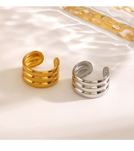 Detail of minimalist triple-layered wavy rings in polished gold and silver metal finishes