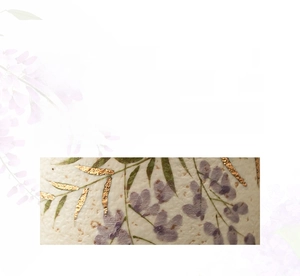 Detailed macro view of hand-painted wisteria with gold accents on high-quality ceramic cup