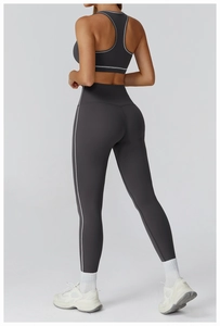 Detail view of dark grey yoga set with contrasting white stitching on high waist leggings