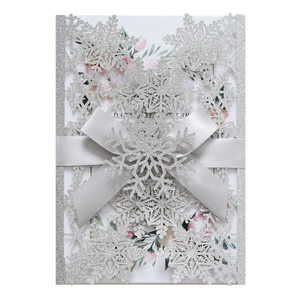 Silver glitter laser cut snowflake wedding invitation with grey ribbon and floral insert