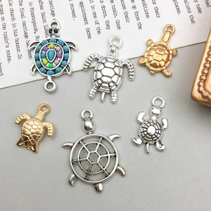 Macro shot of assorted sea turtle charms in gold and silver finish for DIY jewelry