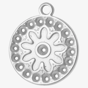 Detail of round stainless steel pendant with floral relief and textured dots