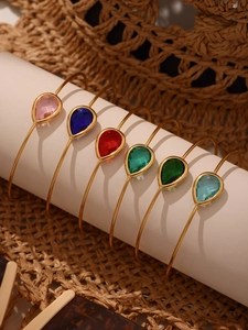 Detail of 18k gold plated open bangles with colorful teardrop Czech glass stones