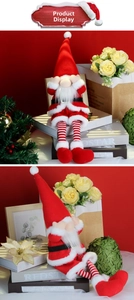 Close-up of a Christmas gnome plush doll with long legs and a red pointed hat for decor