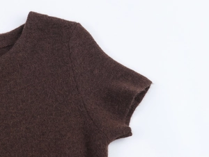 Close-up of dark brown faux fur collar and knit stitching details on the dress