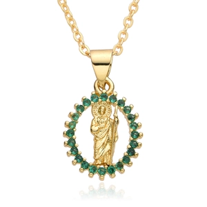 Detailed macro of gold St. Jude religious pendant with vibrant green zircon stones