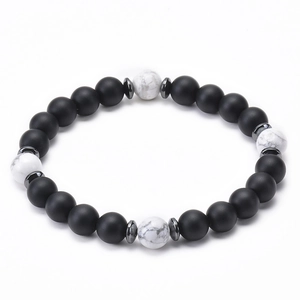 Close-up of 8mm black lava stone bracelet with white marble beads and silver spacers