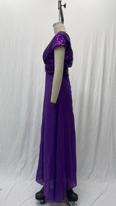 Detail view of the deep purple sequined bodice and flowing chiffon skirt on a dress