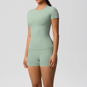 Detail of mint green yoga set showing high-waisted shorts and slim-fit short sleeve top