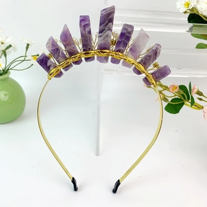 Detailed macro of handmade purple amethyst crystals and pearls on a gold crown headband