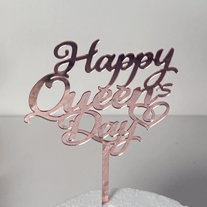 Κοντινό πλάνο διακόσμησης τούρτας Happy Queen's Day από ακρυλικό καθρέφτη rose gold