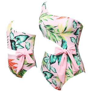 Pink tropical palm print one-shoulder swimsuit with waist cutout and bow for mother and daughter