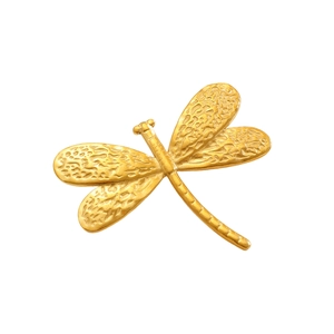 Detail of golden dragonfly brooch showing vintage hammered texture and wing patterns