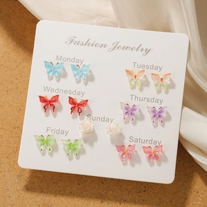 7-day butterfly earring set with colorful resin studs on a daily display card