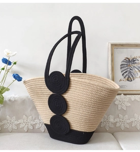 Detailed macro view of beige and black woven cotton rope texture on a beach tote bag