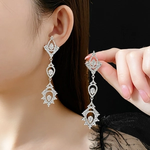Close-up of elegant silver tassel drop earrings with sparkling rhinestones for formal wear