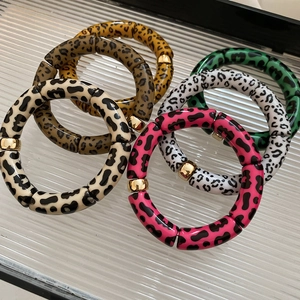 Detailed view of bamboo style leopard print bracelets with polished gold spacers