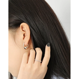 Elegant twisted S925 sterling silver hoop earrings with metallic chain ring on model