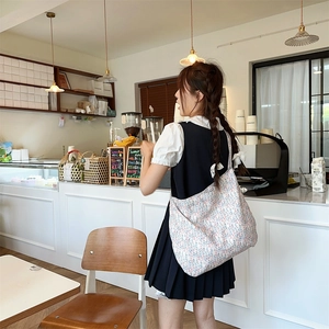Floral canvas tote bag styled with a Japanese pleat dress in a bright modern cafe setting