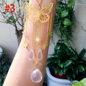 Detail of golden butterfly suncatcher with crystal ball prism for garden and home decor
