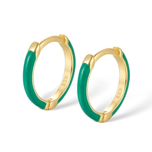 Detail of S925 sterling silver hoop earrings with gold plating and green enamel finish