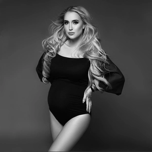 Slim fit black long sleeve maternity bodysuit for professional studio photography