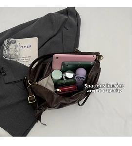 Top view of large brown tote bag interior with storage for tablet and essentials