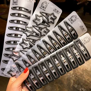 Matte black metal hair clips set with star and rectangle shapes in 10-piece packaging