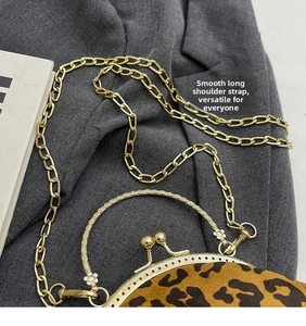 Detail of leopard print shell bag with gold clasp and textured chain strap