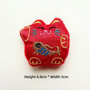 Detail of red Maneki Neko lucky cat plush charm with embroidery, size 4.8cm x 5cm