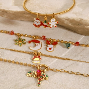 Detailed macro view of gold festive bracelets with colorful Christmas charms and beads