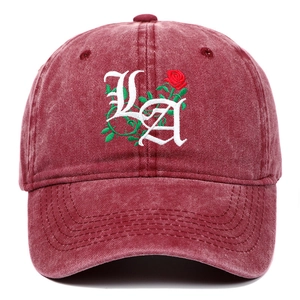 Detailed embroidery of gothic LA letters and red rose on washed burgundy baseball cap