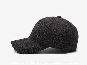 Close-up of winter baseball cap featuring knit texture and metallic B logo on the side