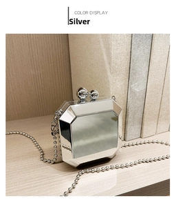 Detail of silver octagonal mirror evening clutch with beaded chain and dual ball clasp