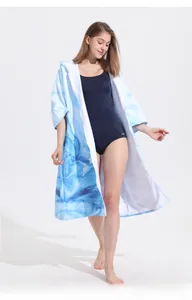 Detail of hooded beach towel robe featuring blue marble pattern and front zipper closure