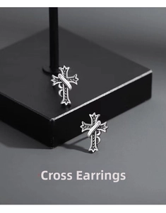 Macro detail of S925 silver cross earring with vintage black zircons on display stand