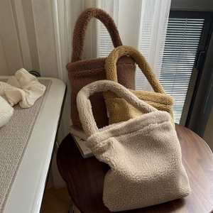 Detailed texture of fuzzy fleece tote bags in cream, yellow, and brown colors