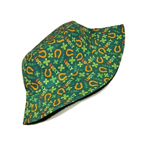 Detail of St. Patrick's Day bucket hat with green clover and lucky horseshoe patterns