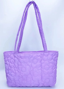 Close-up of the light purple quilted tote bag featuring a 3D floral sun flower texture