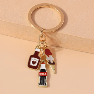 Gold keychain featuring cute cola bottle, red wine jar, and strawberry ice cream charms