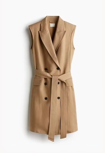 Detail of camel sleeveless blazer dress with double-breasted buttons and waist belt
