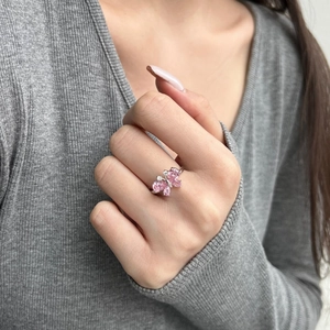 Detail of S925 silver ring featuring pink heart butterfly diamond on model's hand