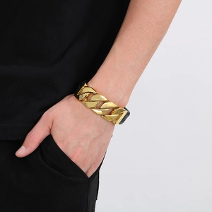 Men's gold Cuban chain bracelet with black leather and square magnetic clasp on wrist