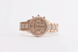 Detail of rose gold quartz watch featuring rhinestone bezel and three-dial chronograph