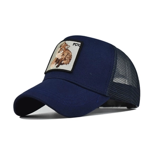 Detailed view of breathable mesh and embroidered fox patch on the navy trucker cap