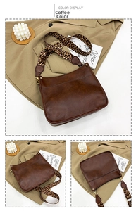 Macro detail of dark brown PU leather tote with leopard strap and gold hardware